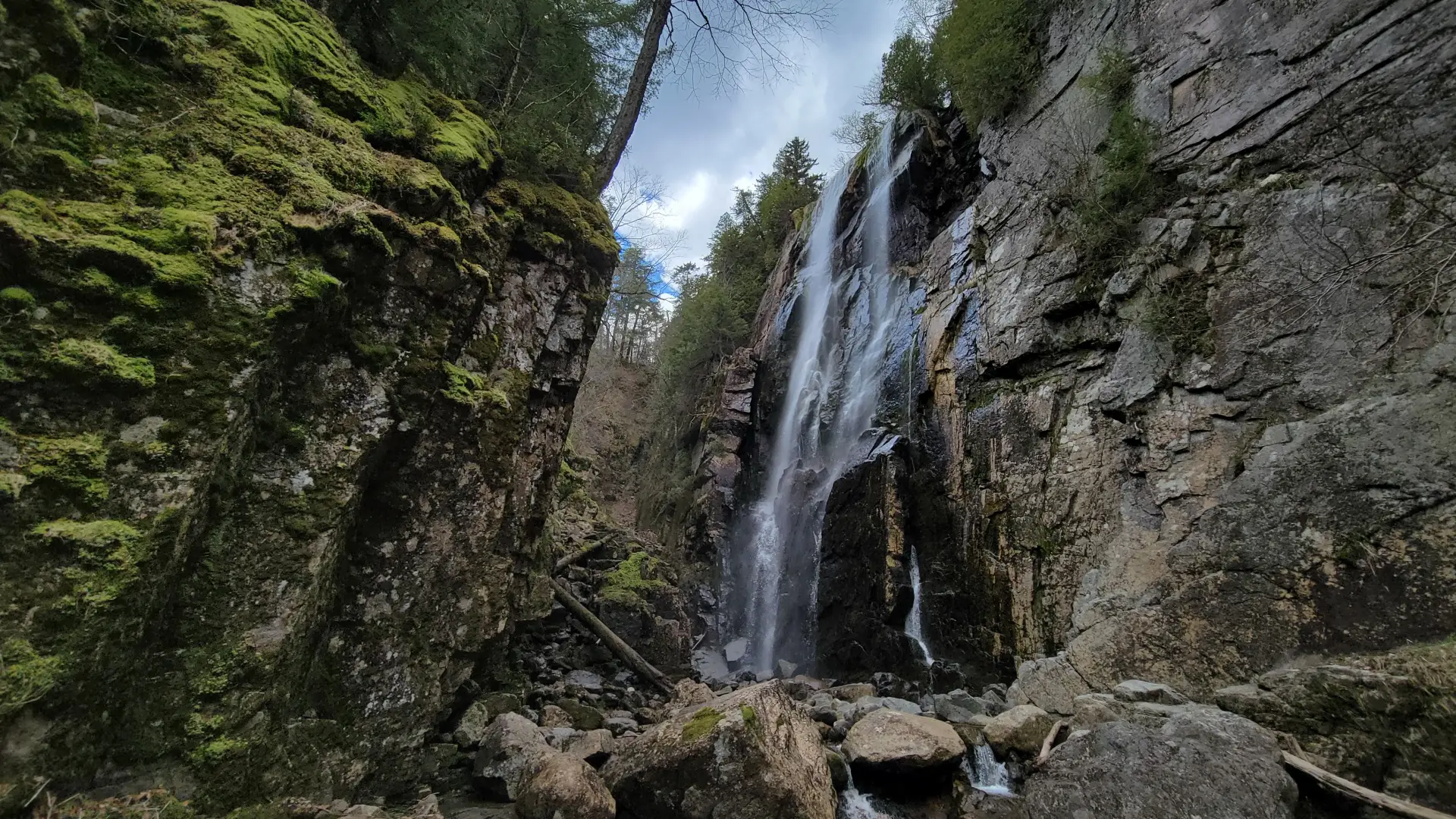 A large waterfall in a narrow granite canyon