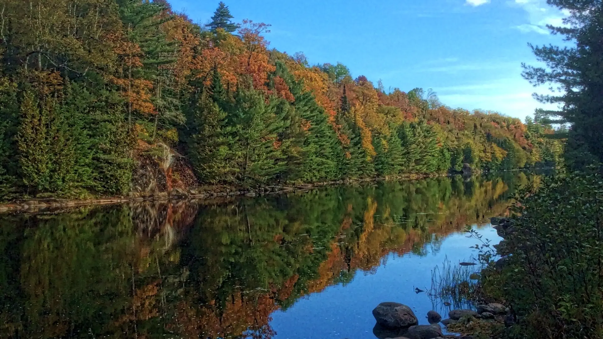 The road continues past the river, upstream of the dam.