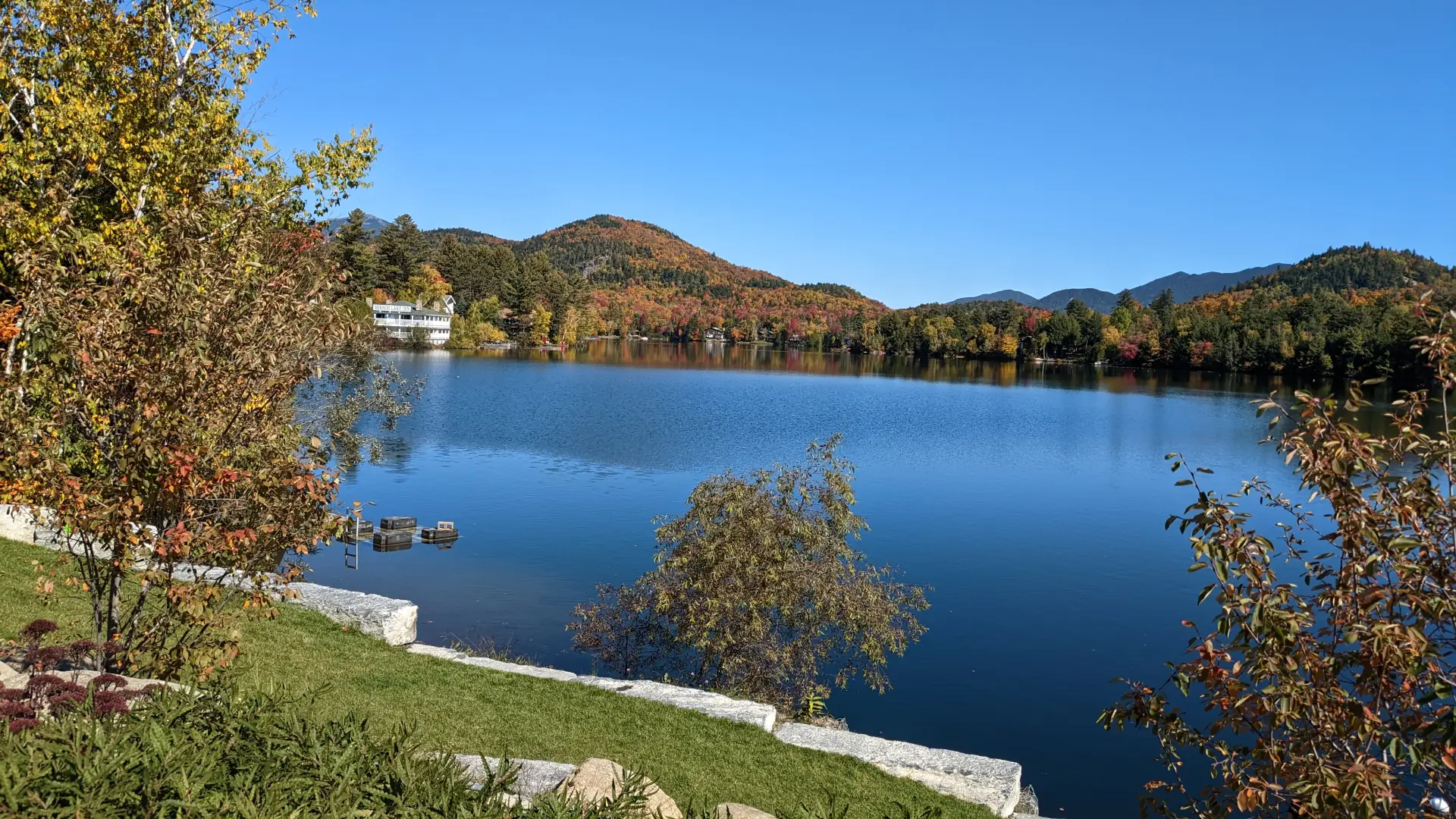 A view of Mirror Lake with mountains and trees in the backdrop