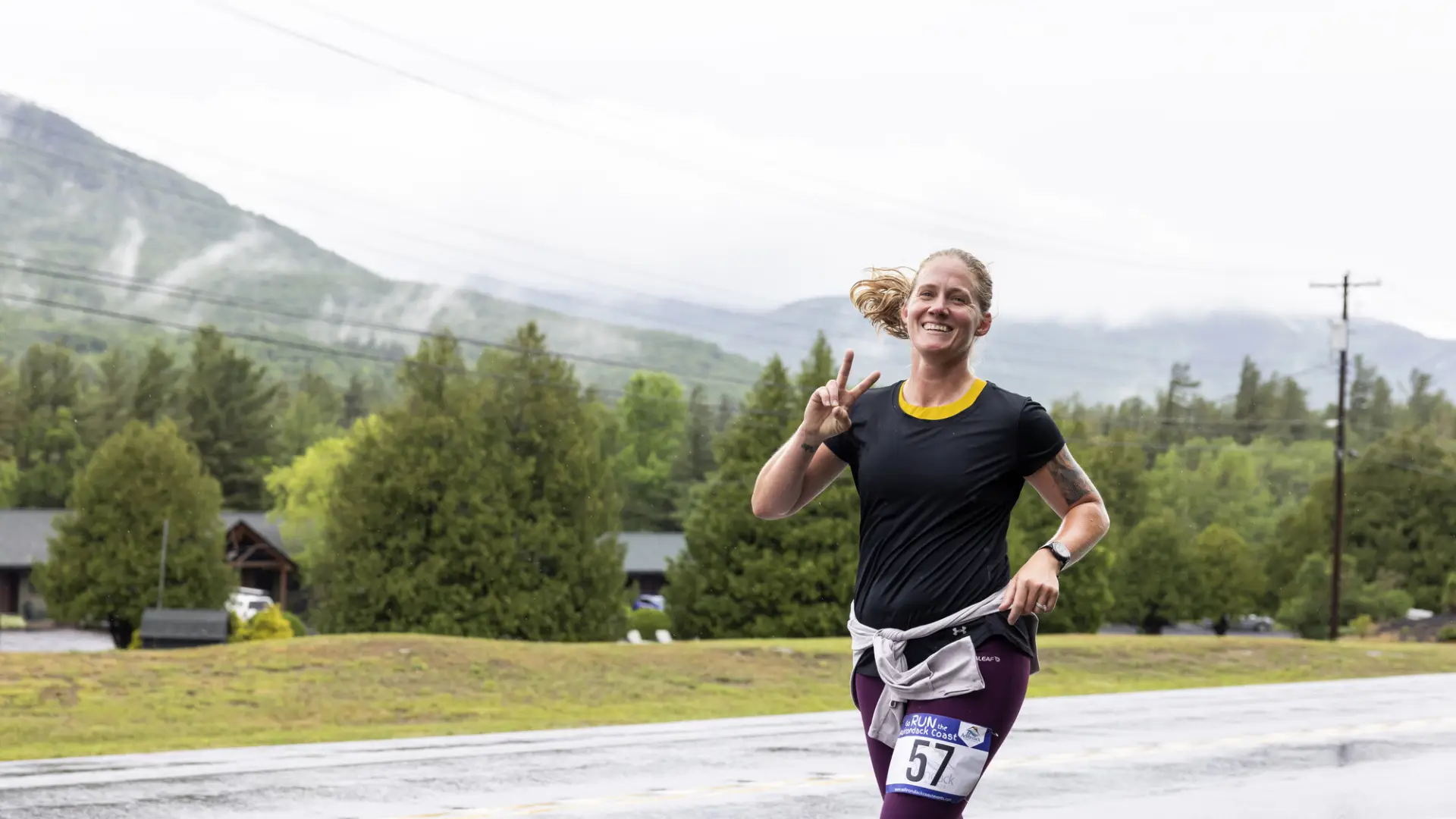 Racer smiles at camera with mountain in background
