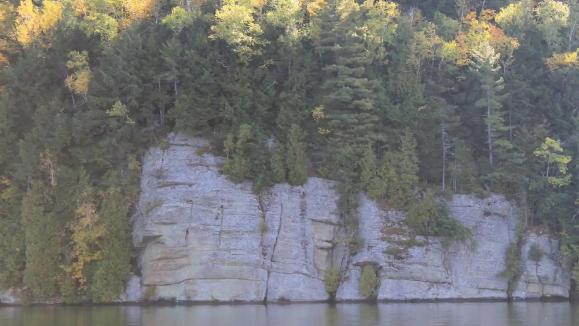 A white rock slab that leads into water.