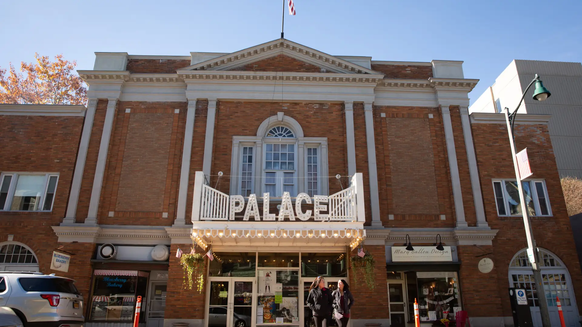 The exterior of a classic movie theater with brick facade and old-fashioned marquee.