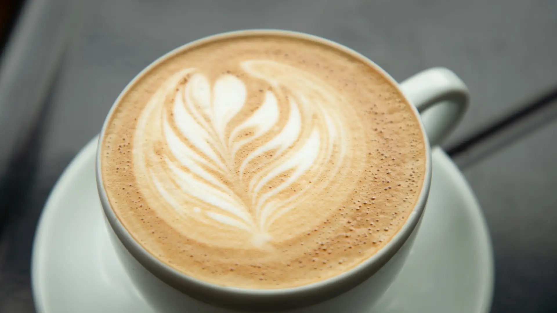 A freshly-made coffee with foam art in a white mug