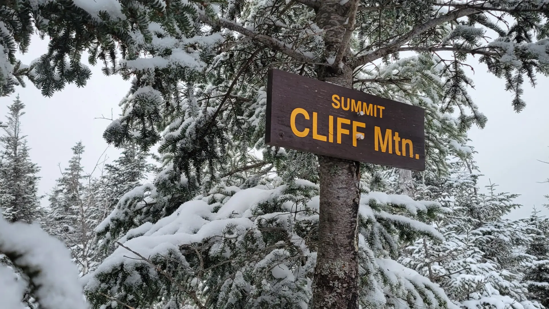 A wooden sign for the summit of Cliff Mountain