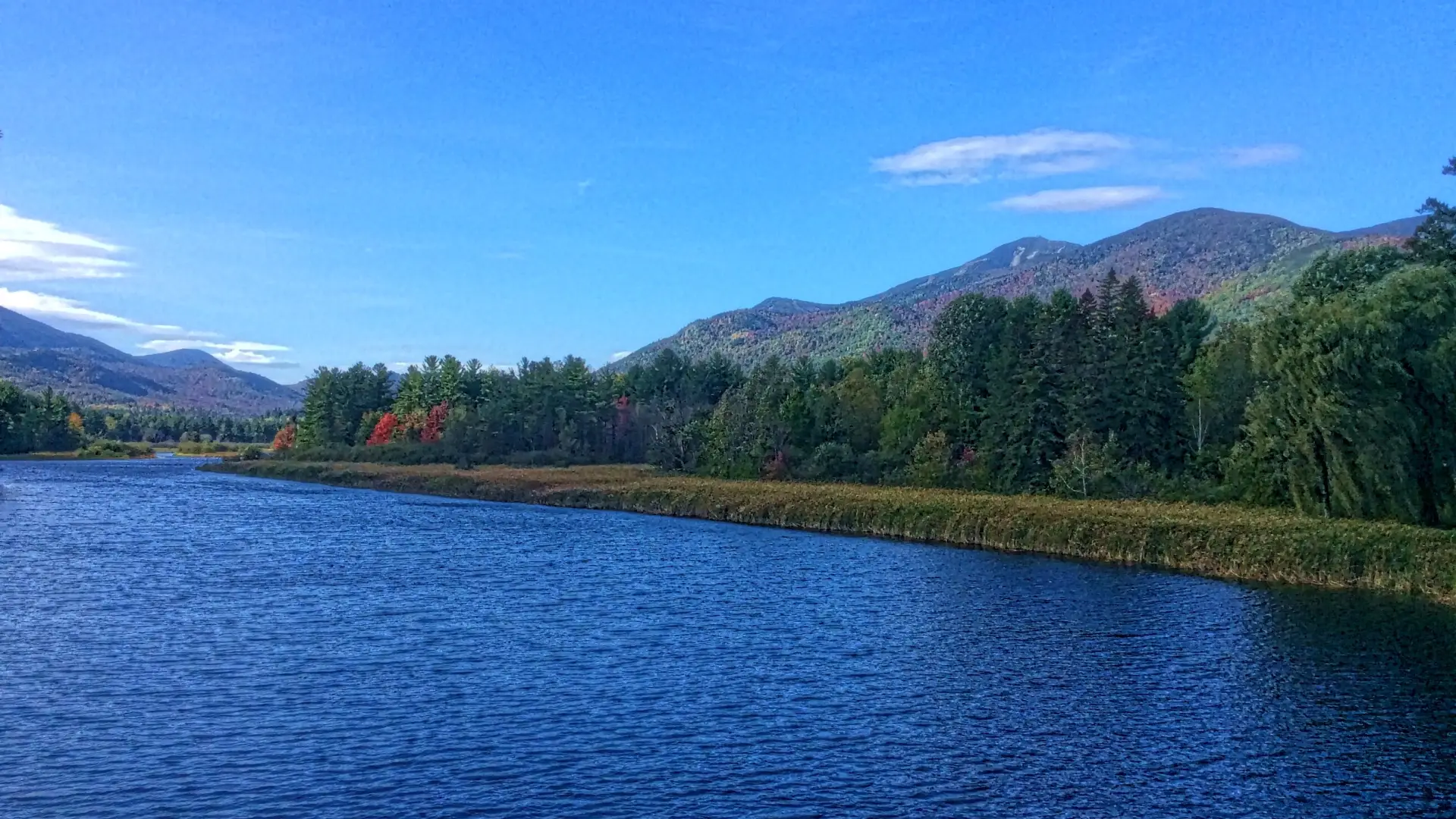 The blue of the sky matches the blue of the lake in the Adirondacks.
