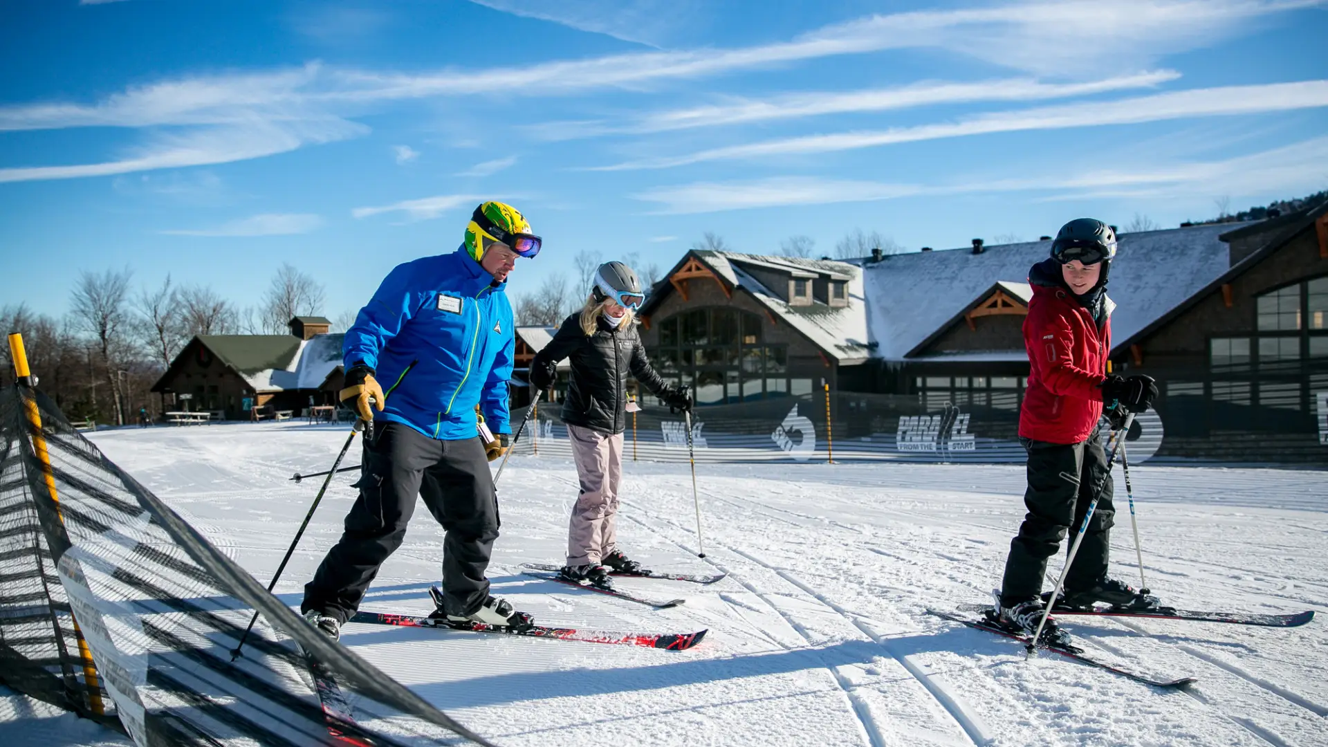 Two women taking a ski lesson with an instructor at Whiteface Mountain.