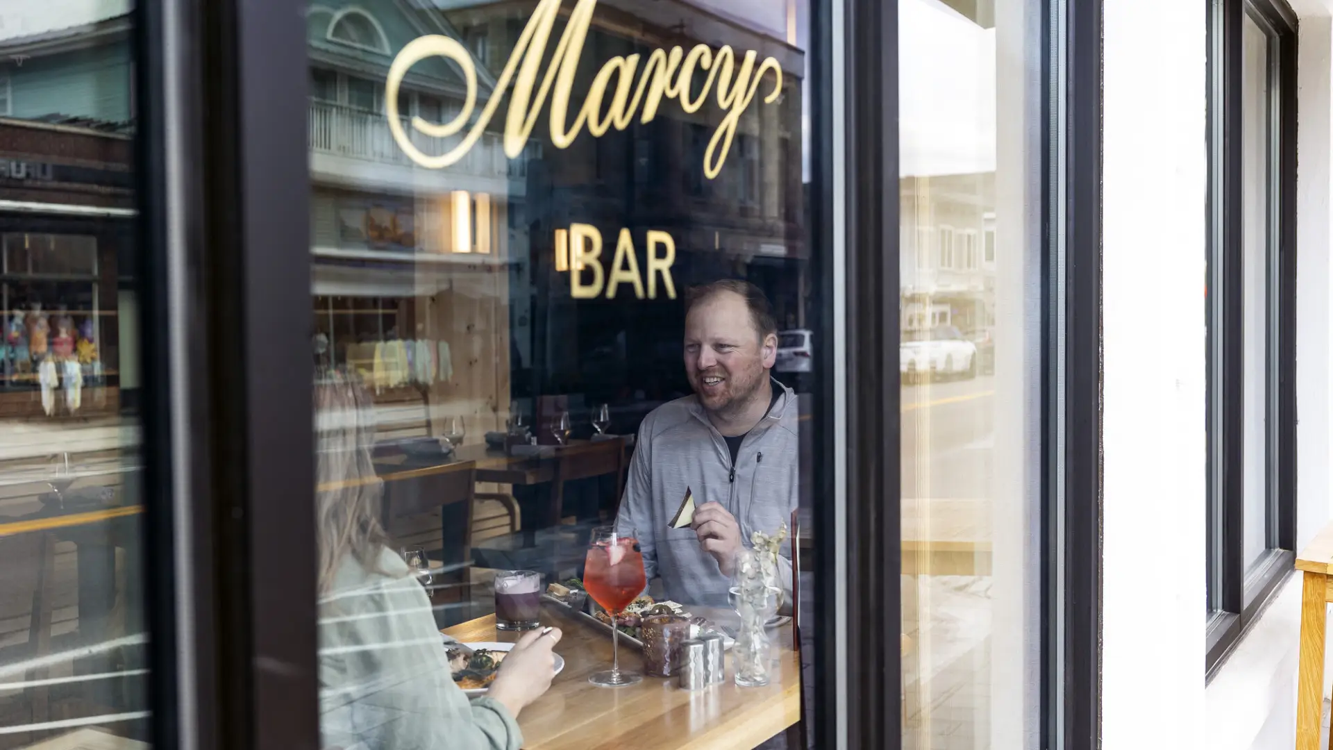 A man and woman enjoy lunch at marcy bar.