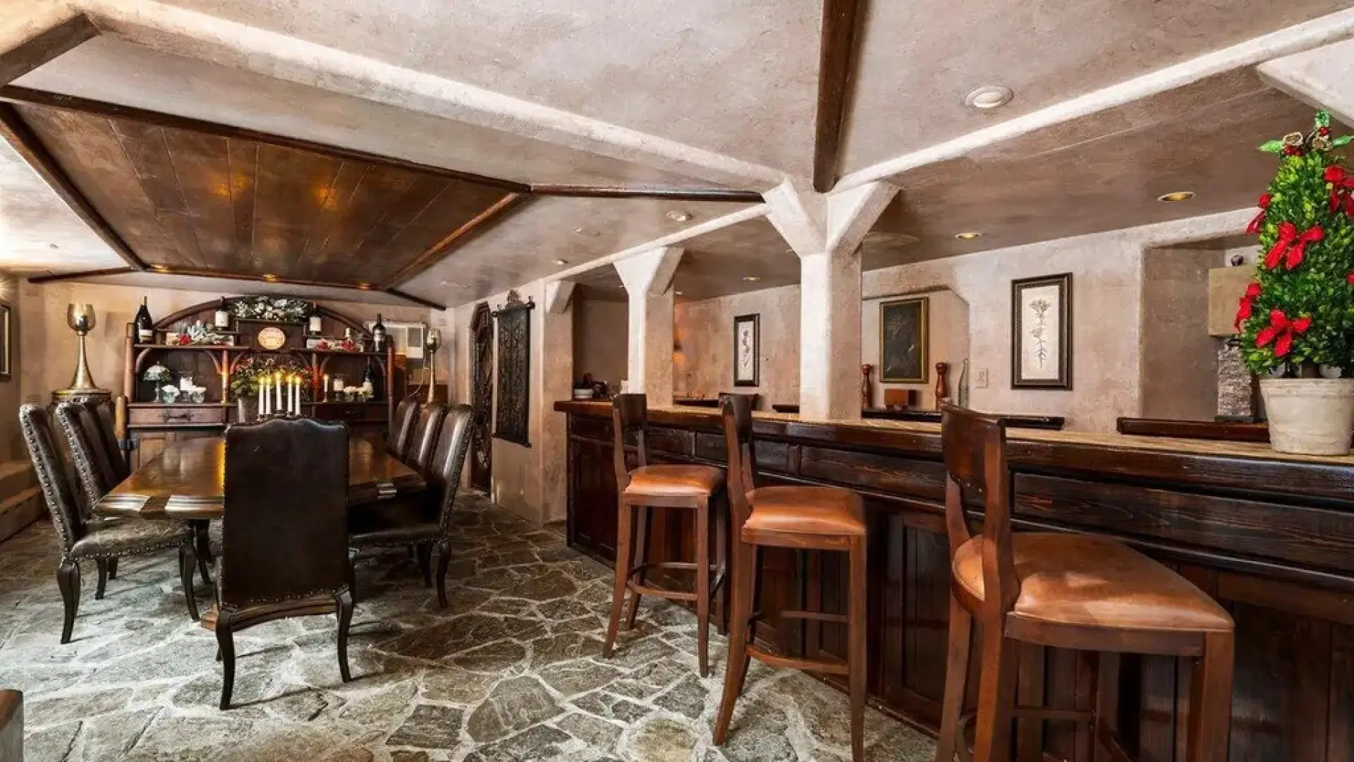 The private dining room with bar area and large table with plush leather chairs.
