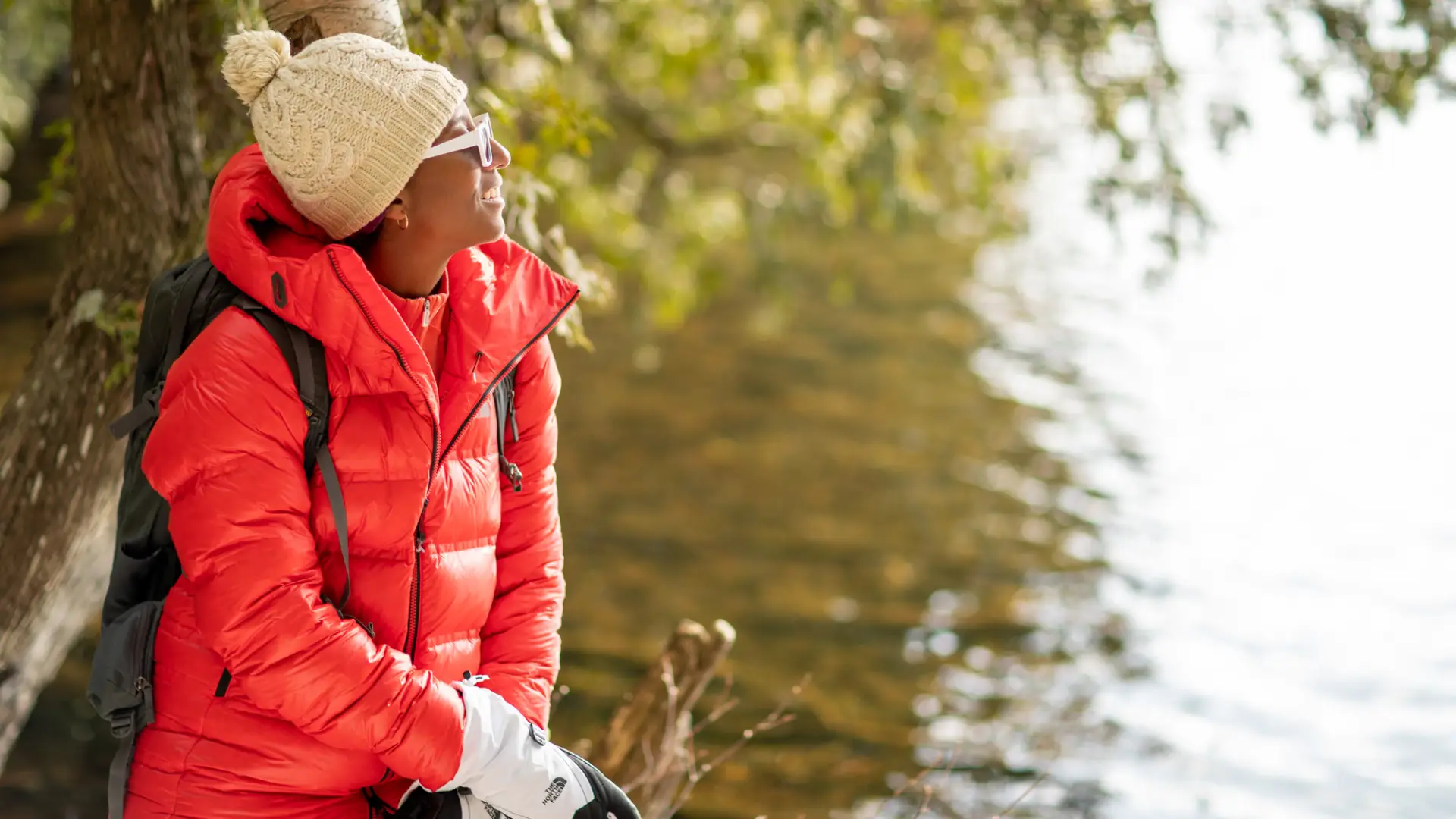 A woman look at a pond from its shores