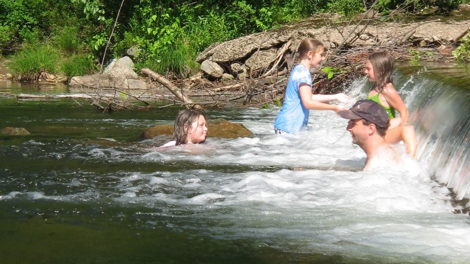 People relaxing and playing in a river