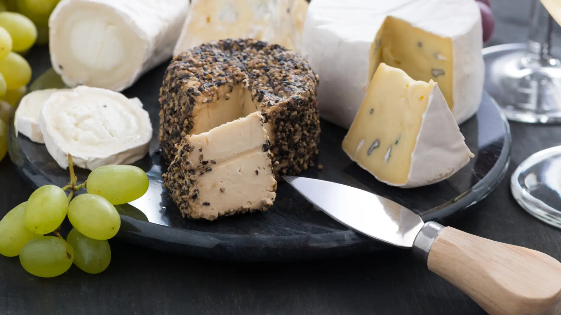 A board featuring assorted cheeses.