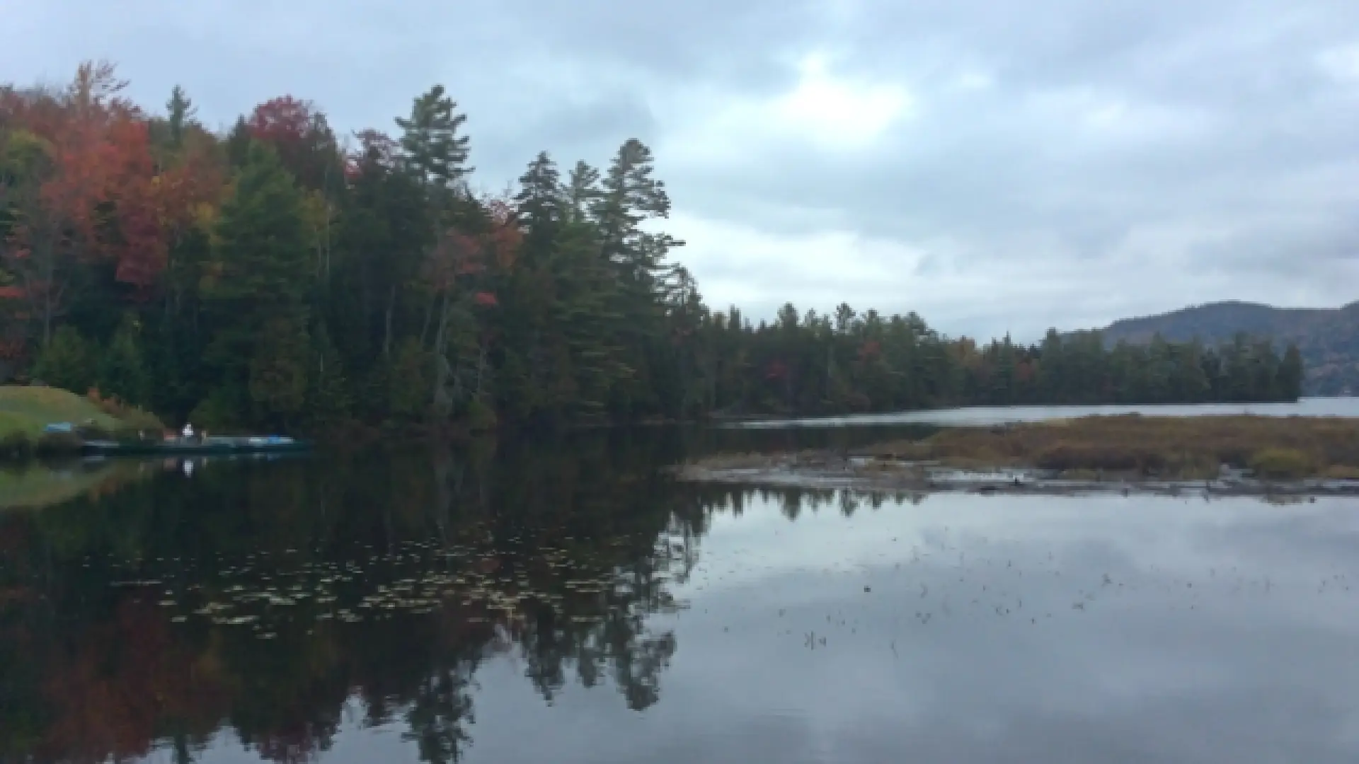 And in back, Lake Placid, the lake. There are canoes and Adirondack chairs and the McKenzie Mountain wilderness in the background.