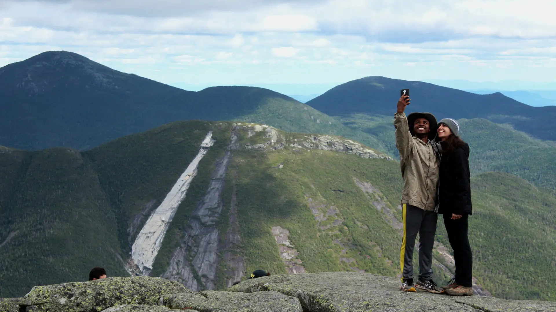 Two people taking a selfie on a mountain