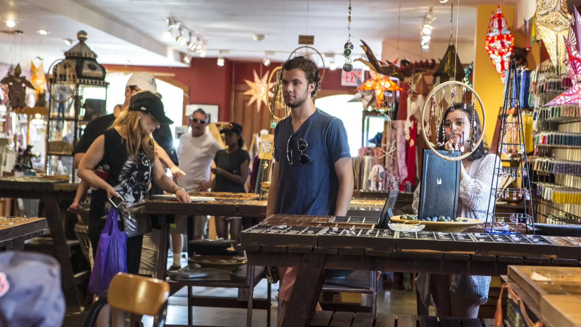 A colorfully decorated bead shop bustles with shoppers.