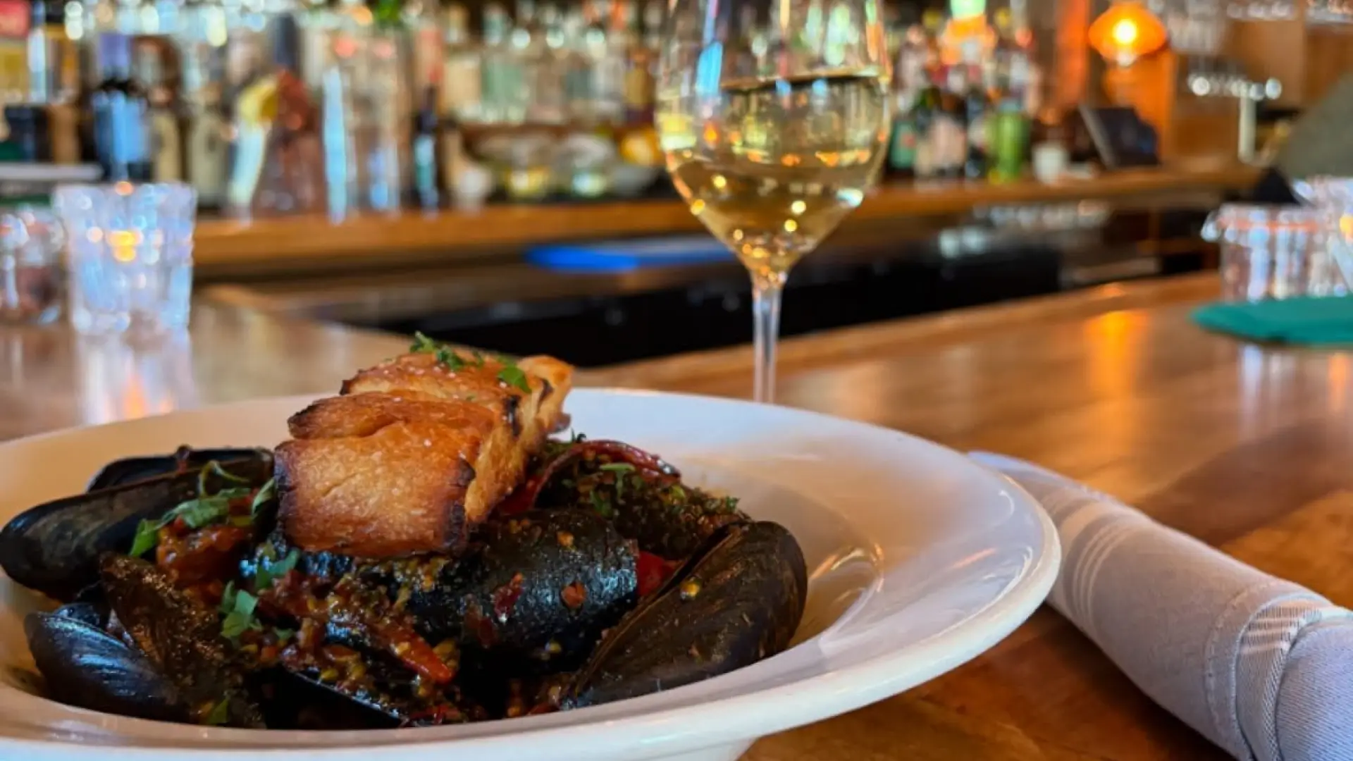 A delicious meal with a glass of wine at the bar