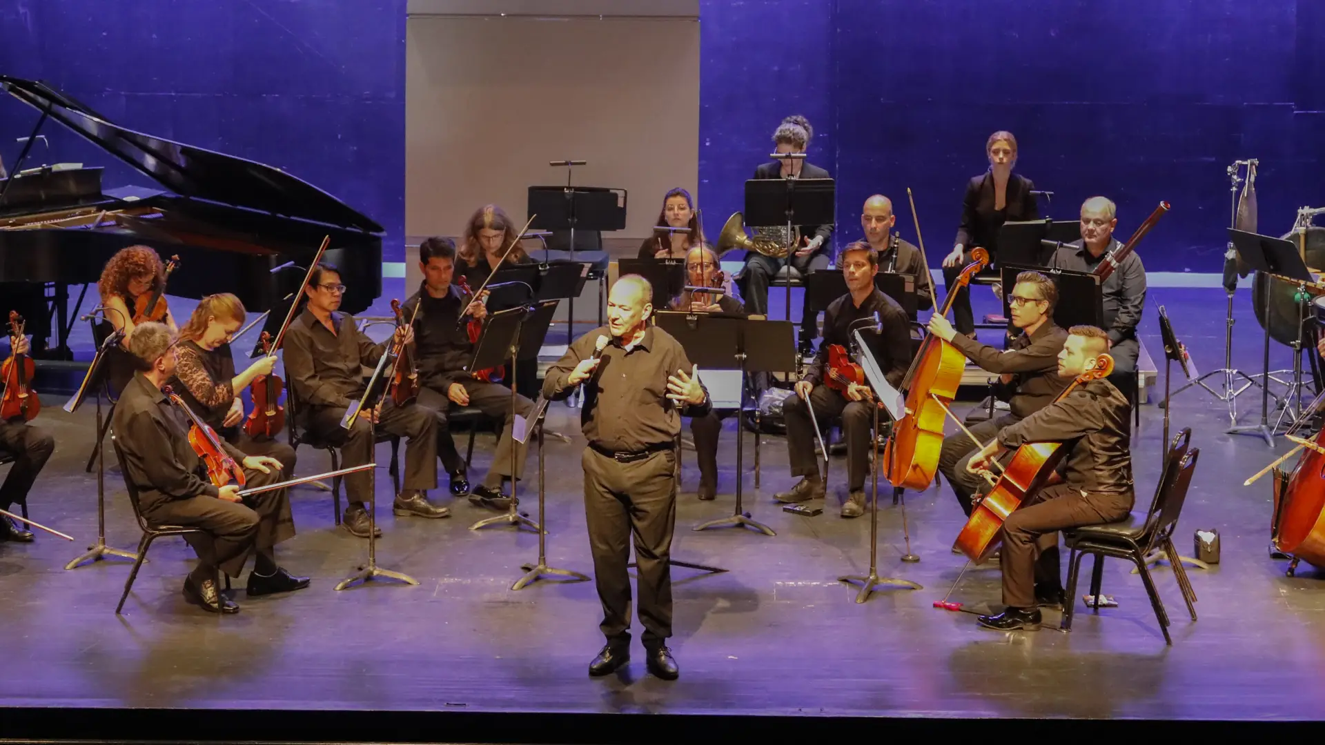 Orchestra on Stage, Conductor addressing crowd Credit to: Lohr McKinstry