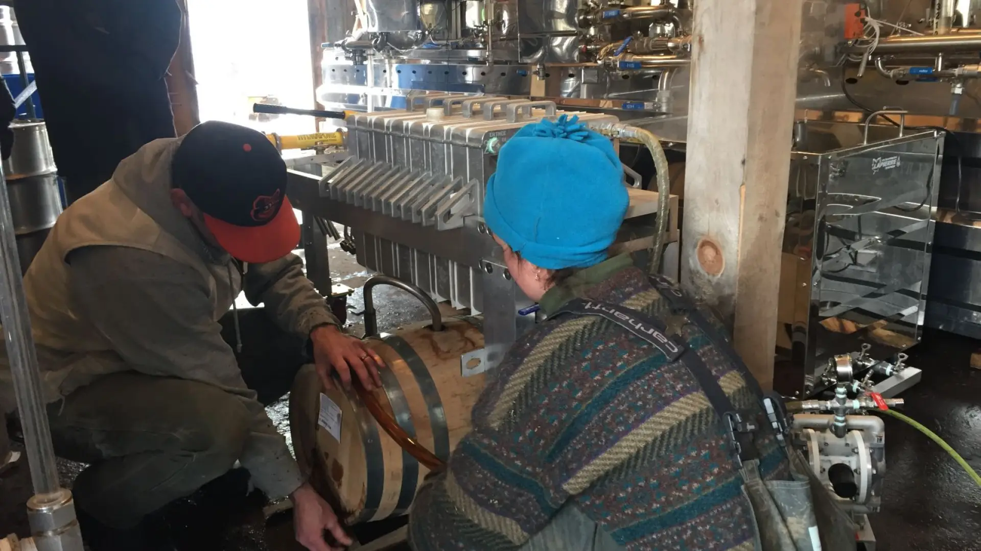 Kirk and Lizzie arranging the bourbon aged barrel.