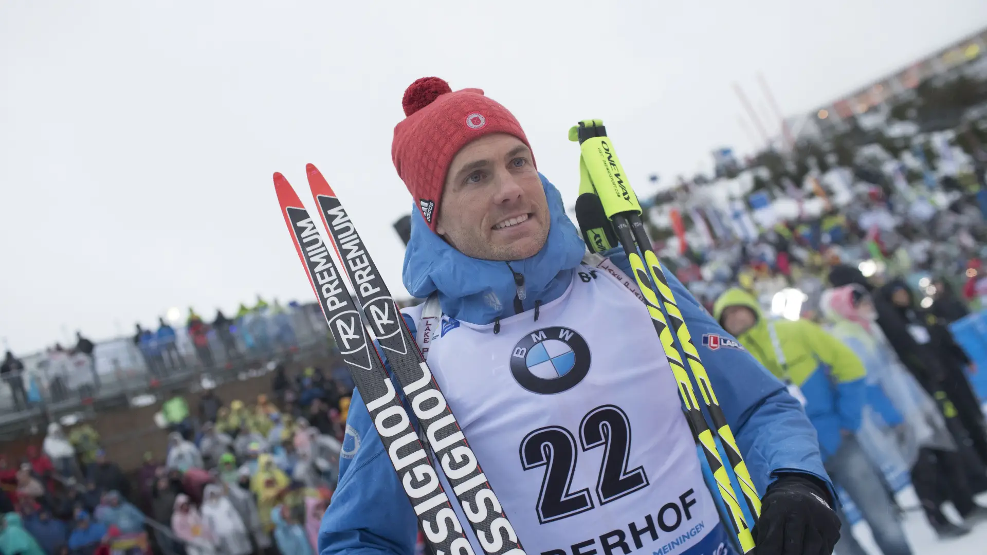 Tim Burke stands with skis and poles after race