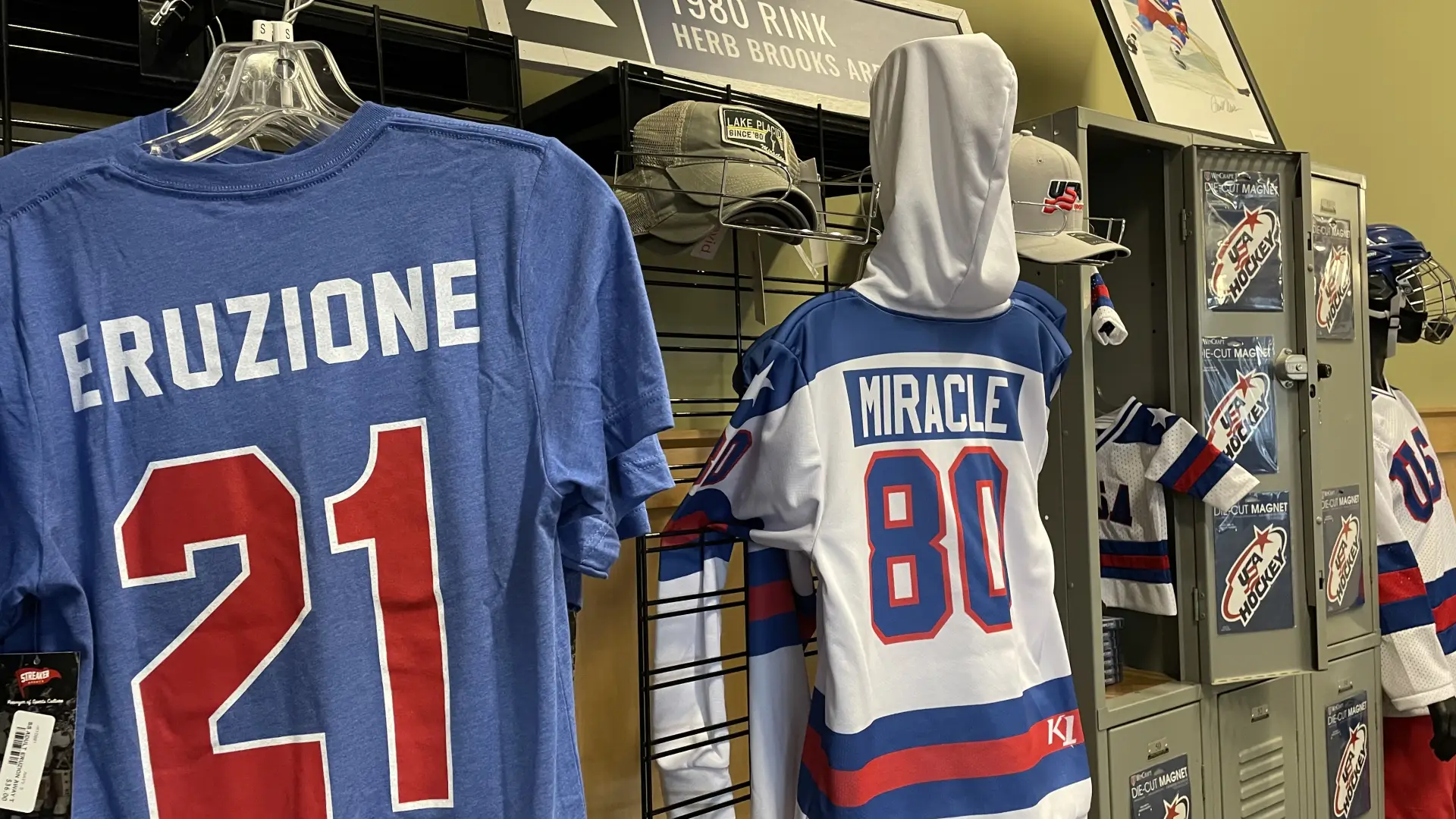 A display of tshirts, jerseys, and other hockey apparel and memorabilia in a shop.