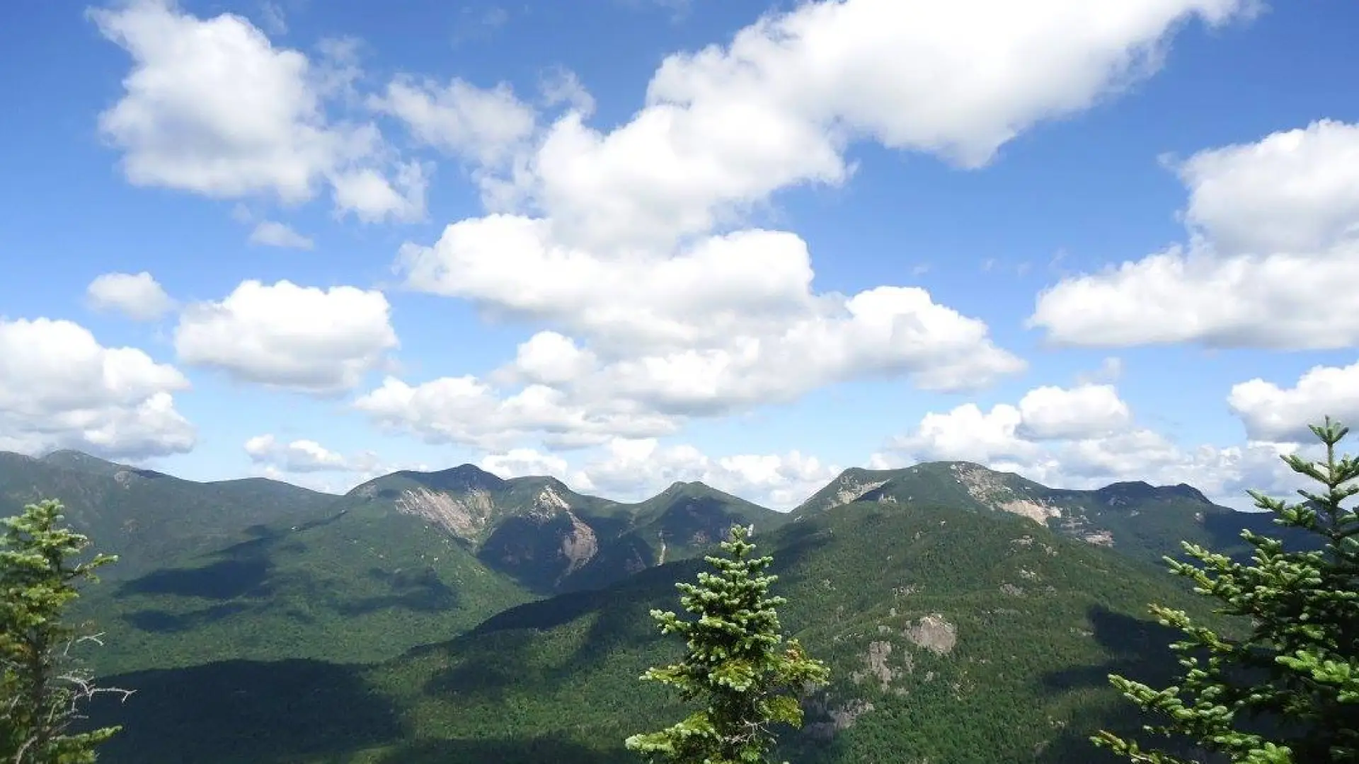 Sweeping view of nearby mountains from the summit of Mount Colvin.