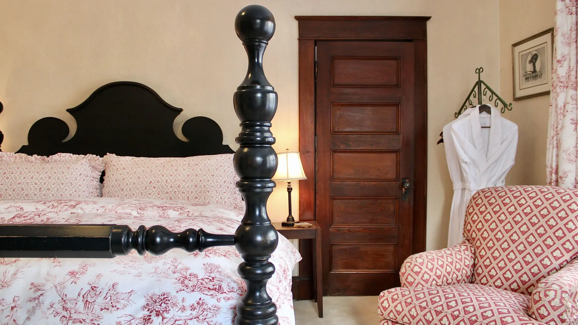 A plush guest room with dark wooden bed.