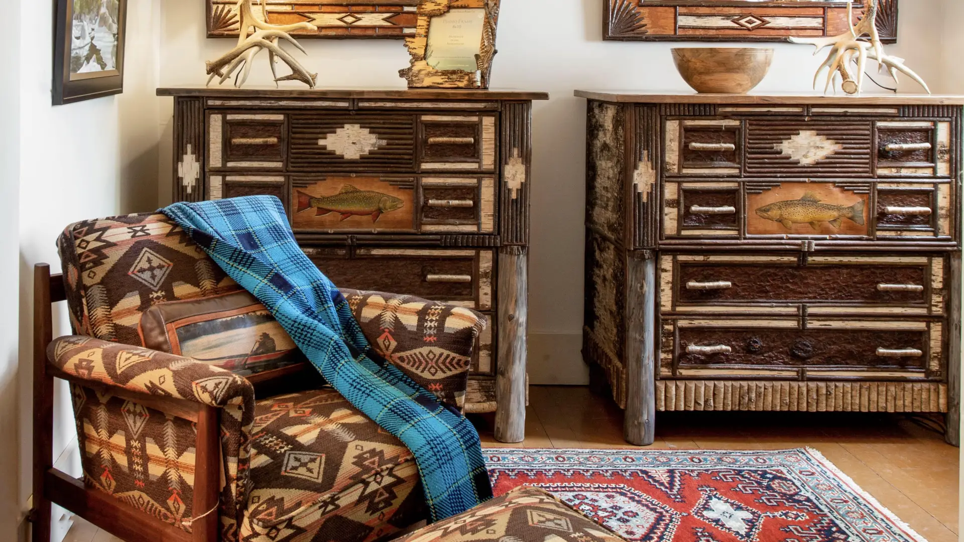 A matching set of birch dressers emblazoned with brook trout.  Birch bark mirrors hang above and the look is completed with matching set of table lamps crafted from antlers.