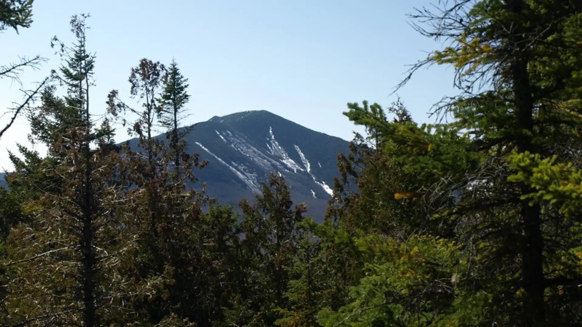 Dix Mountain can be seen from here, with the distinctive stripes of late fall ski trails.
