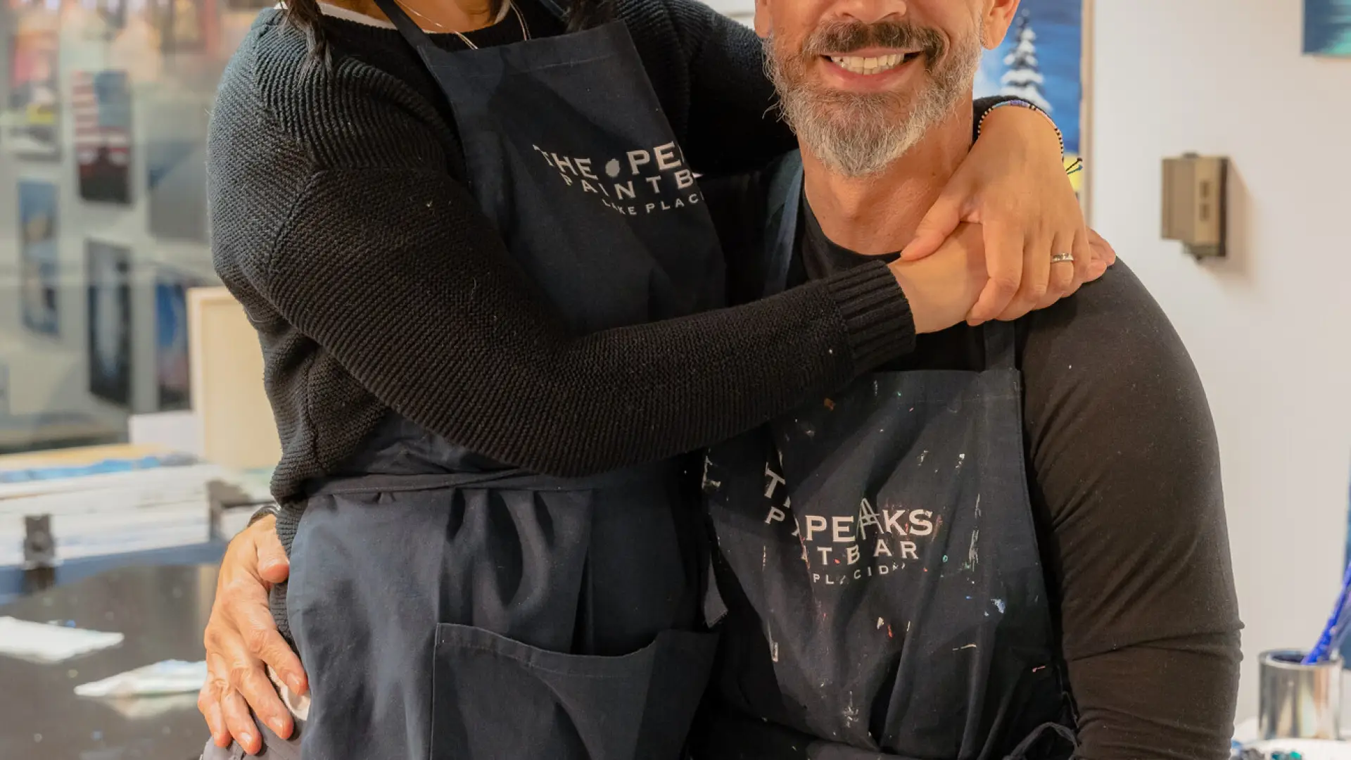 couple posing in front of their business