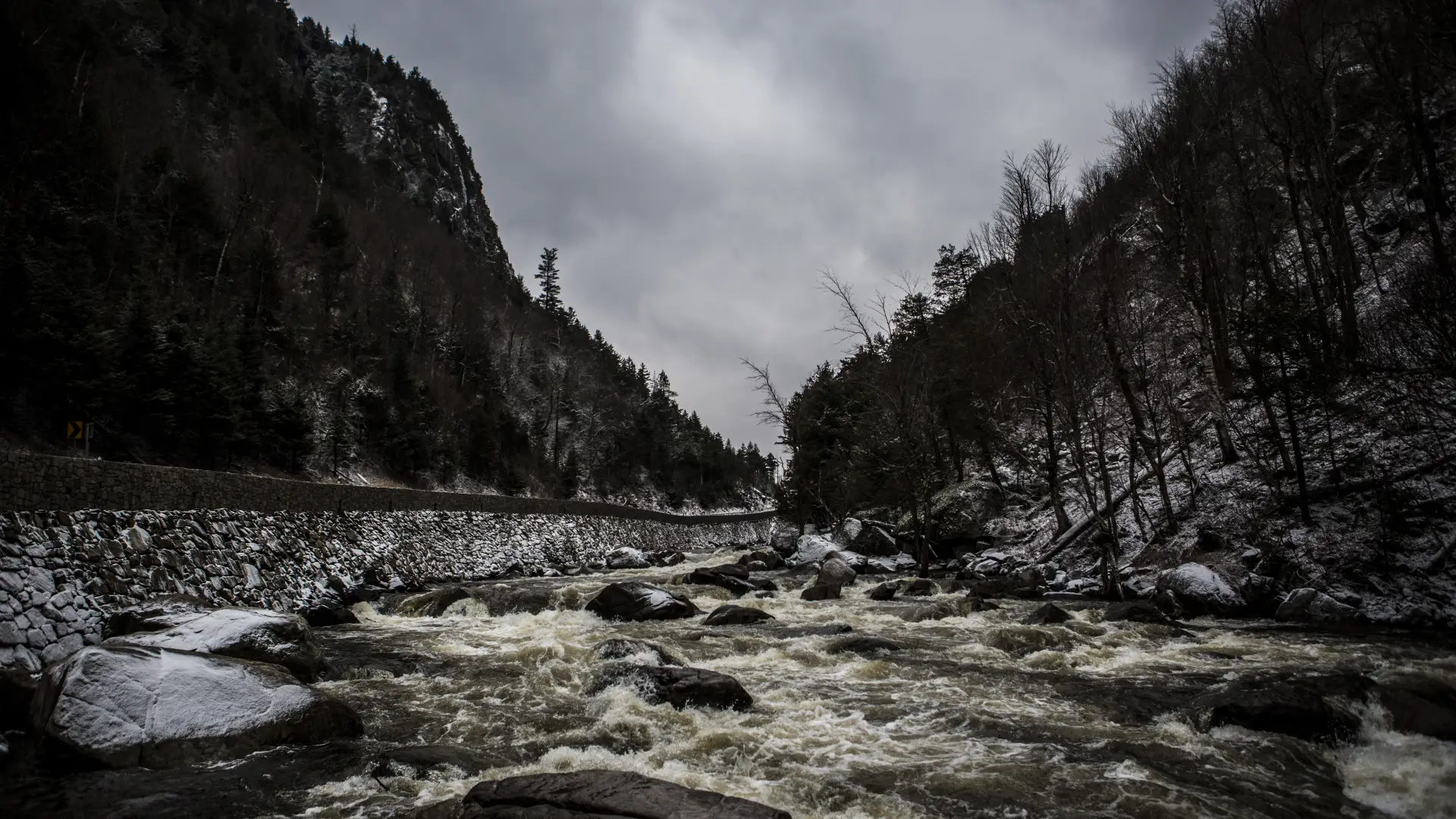 A shallow rock river through a mountain pass