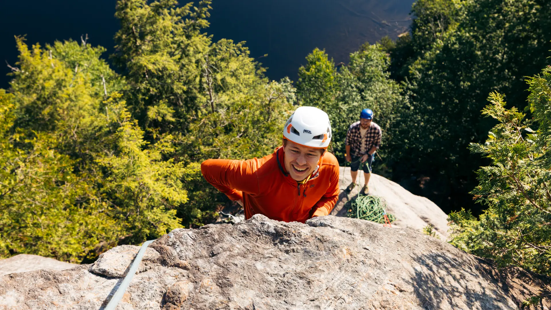 A rock climber ascends a blunt arete