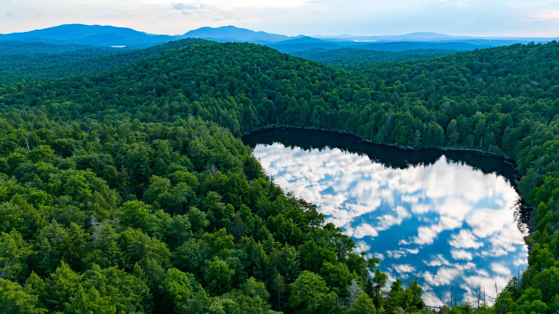 Clouds reflect in an Adirondack Pond