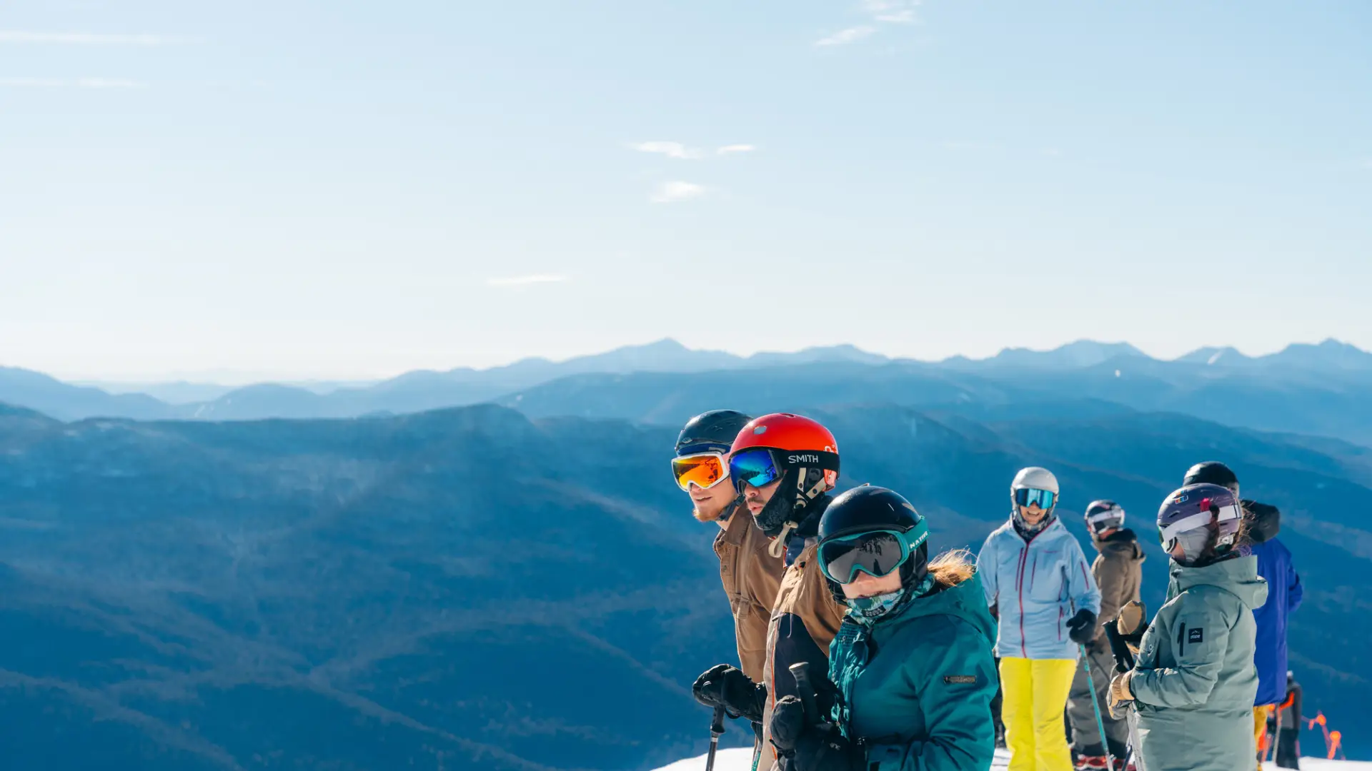A group of skiers looks over a ski slope.