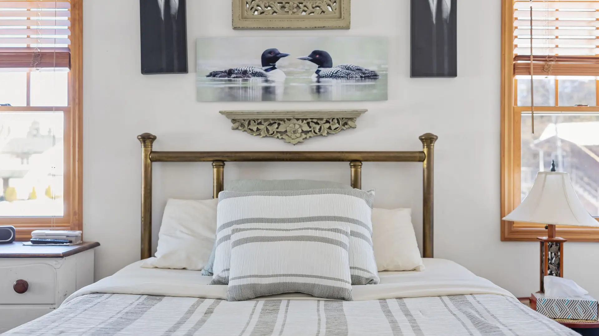 A lush bed with loon images on the lower level at Lake Placid Pinehill Townhouse.