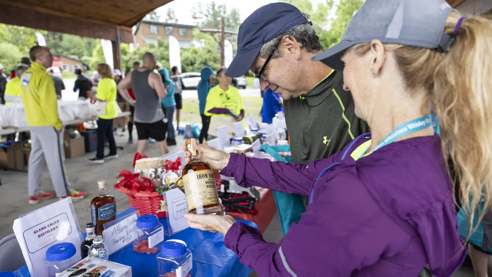 Racers look at whiskey raffle baskets