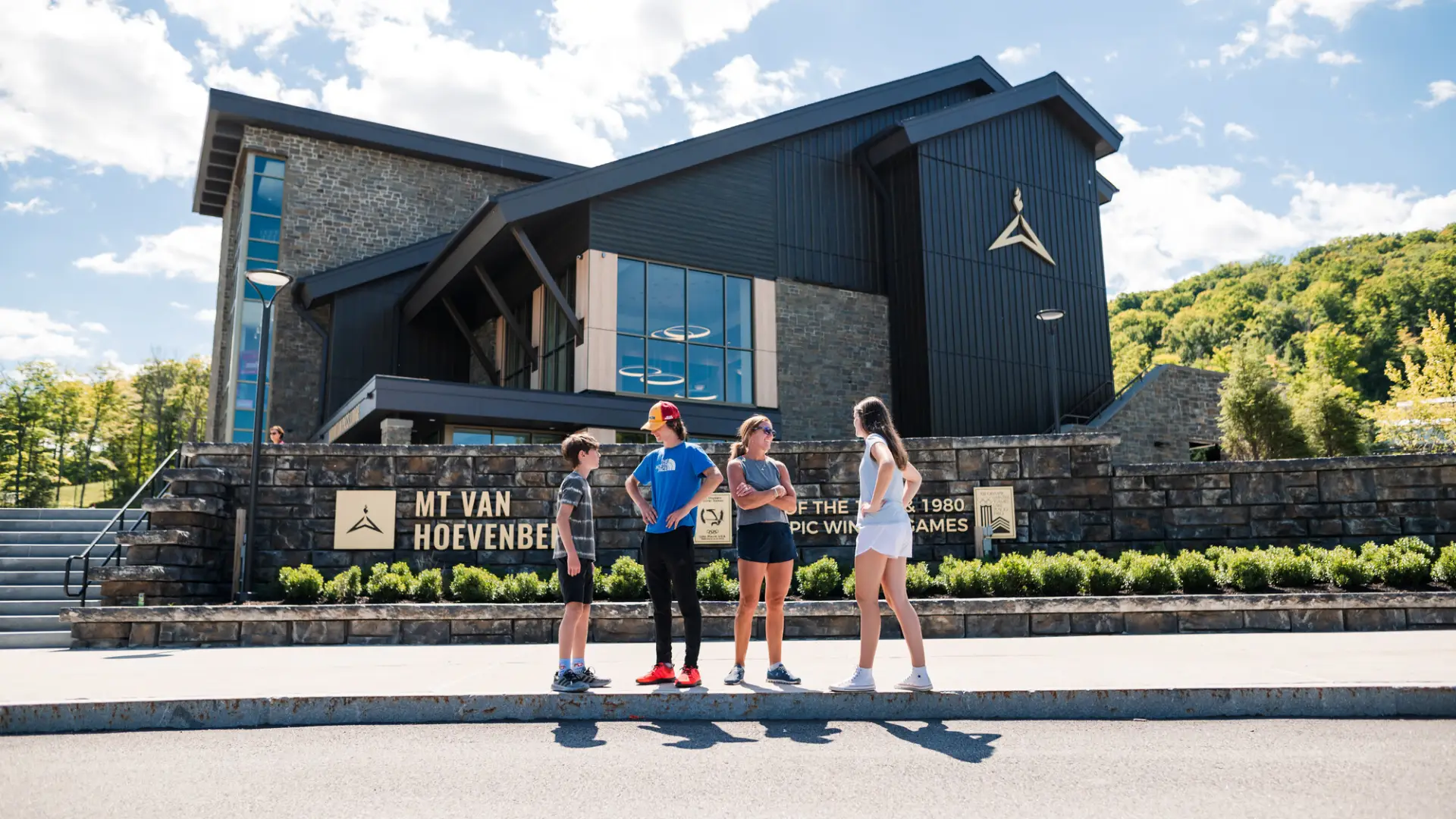 Family stands outside of the Mountain Pass Lodge