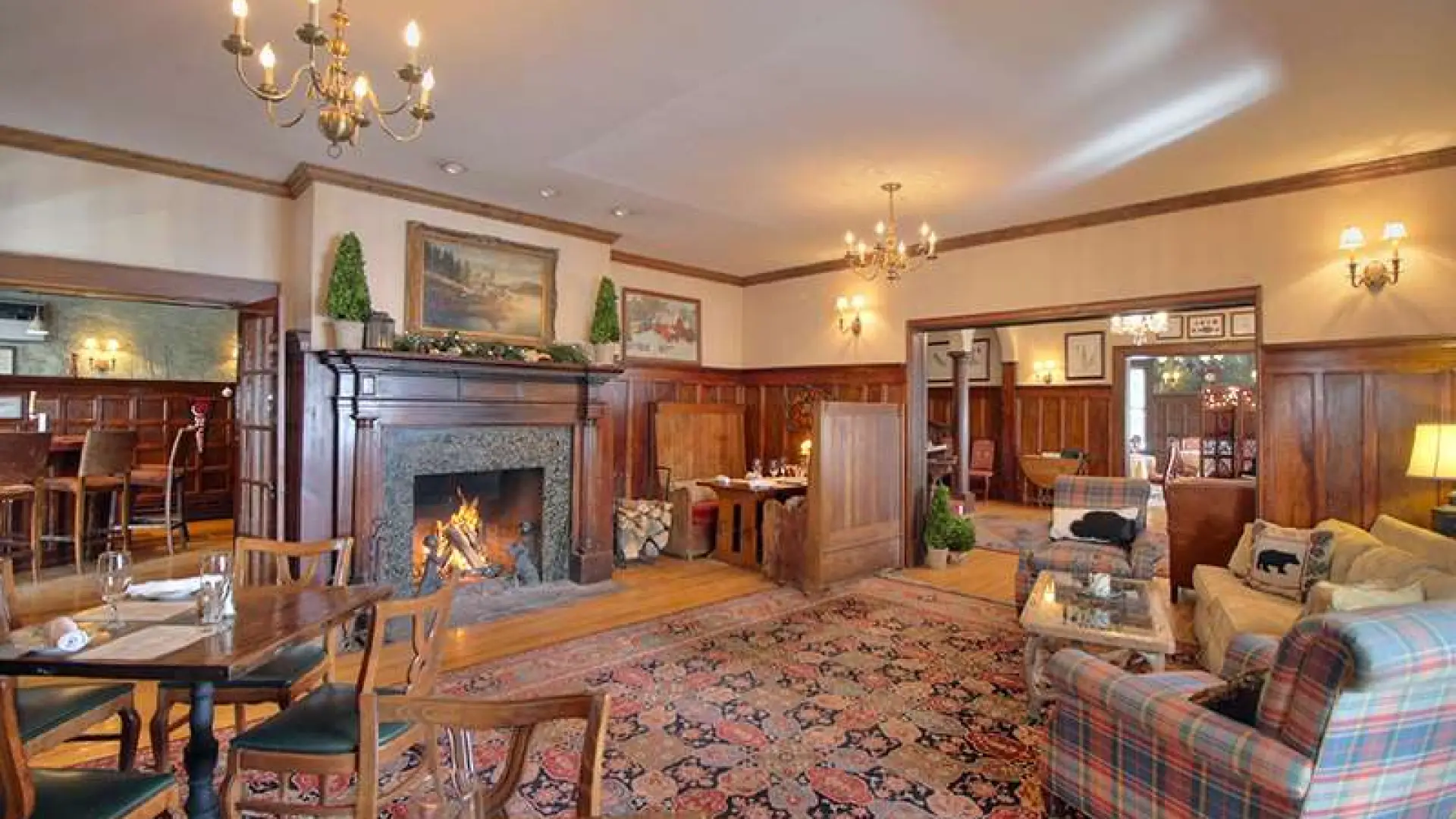 The inviting sitting space by a large fireplace with plush chairs.