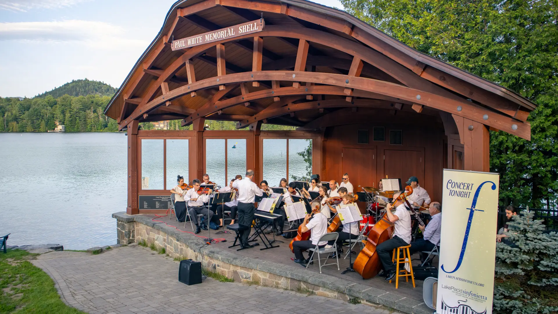 Orchestra in the park shell with Mirror Lake background Credit to: Jacob Rushlow