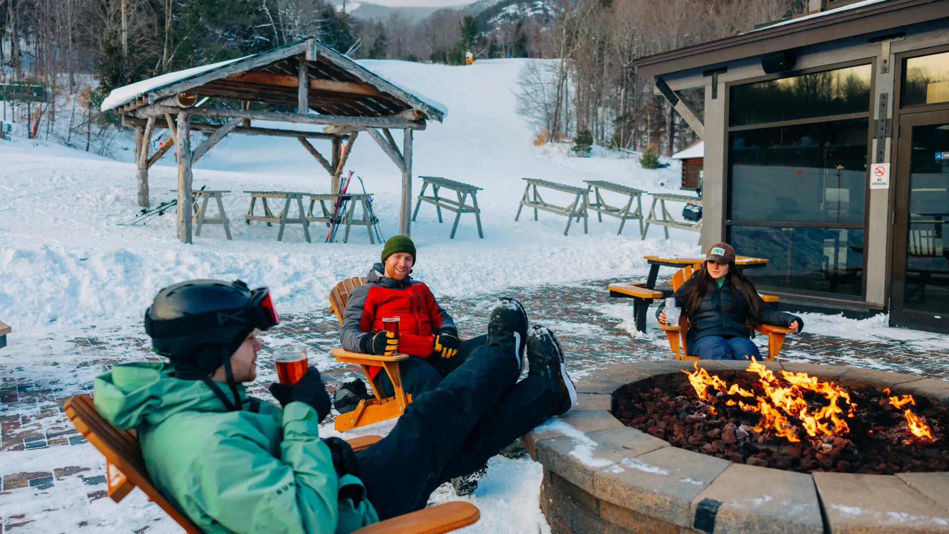 A group sitting by a fire at Whiteface Mountain.