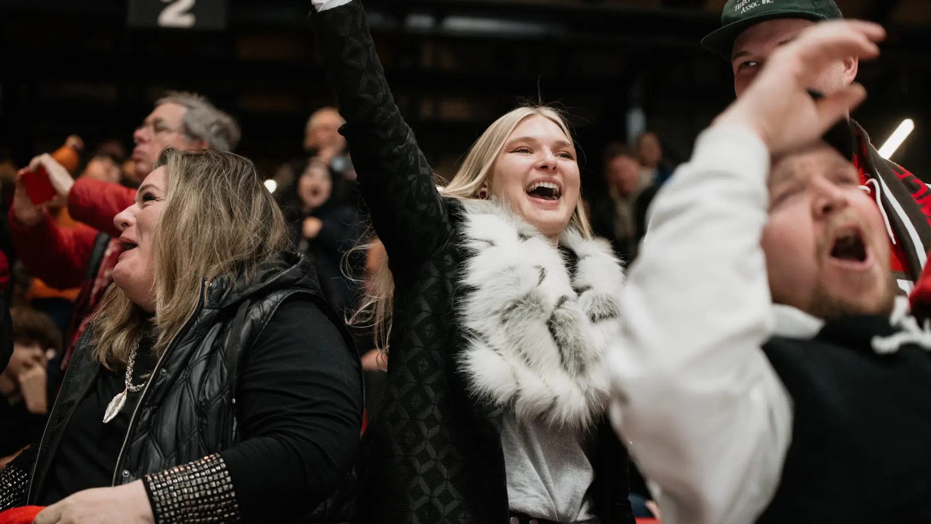 A crowd cheers at an event.