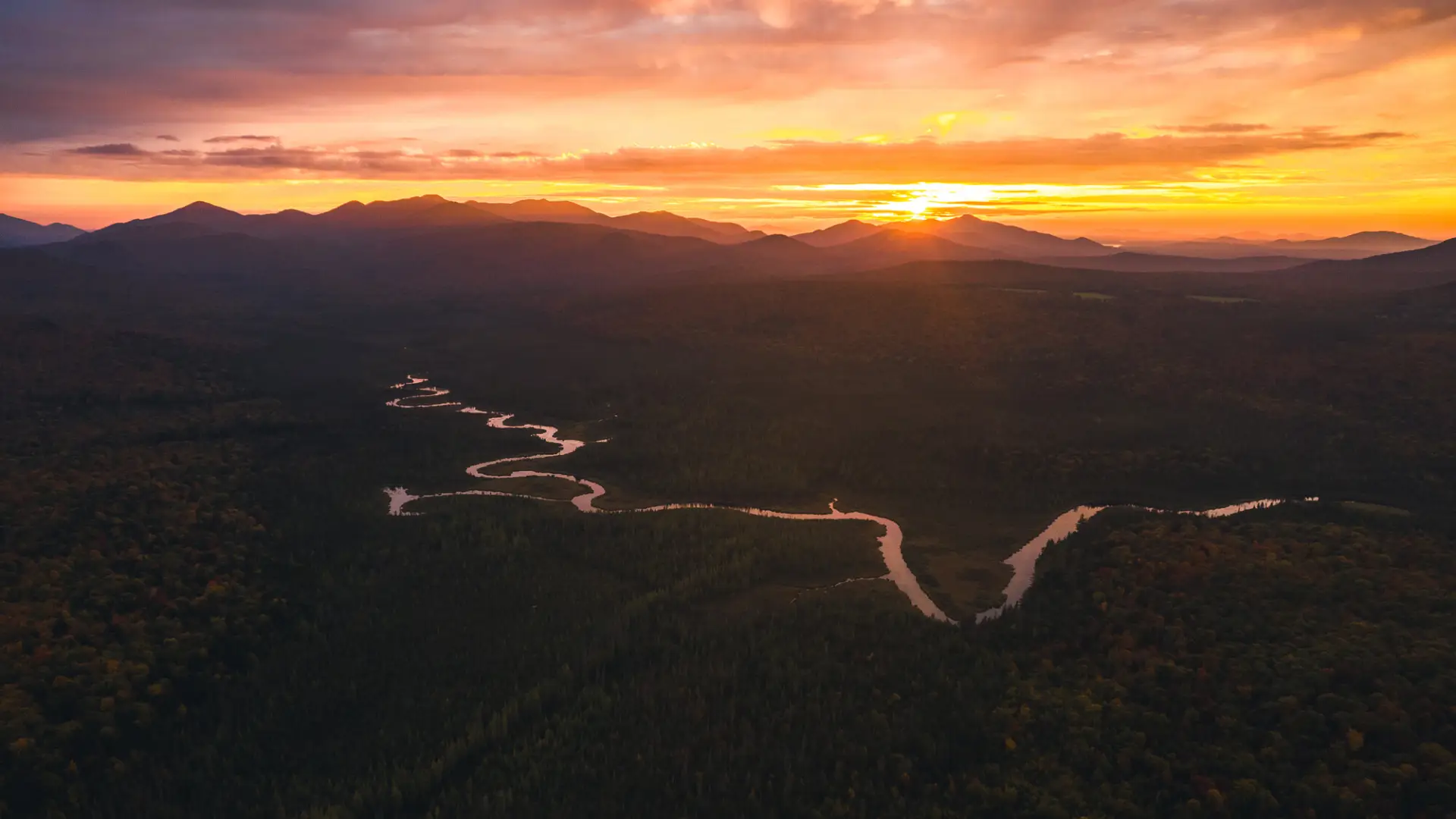 Aerial view of a winding river during sunset