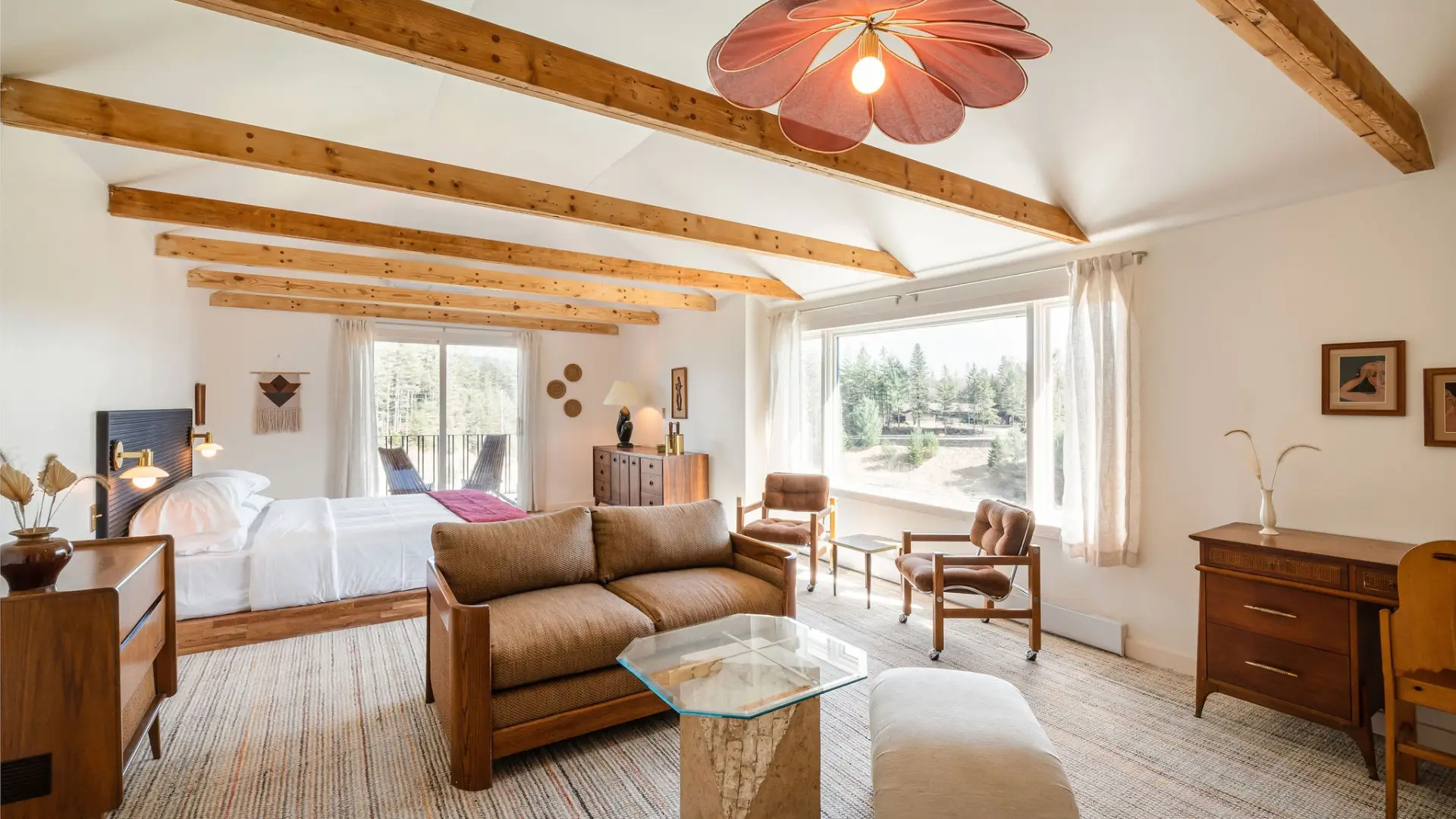 A brightly lit hotel room with scandinavian accents. 