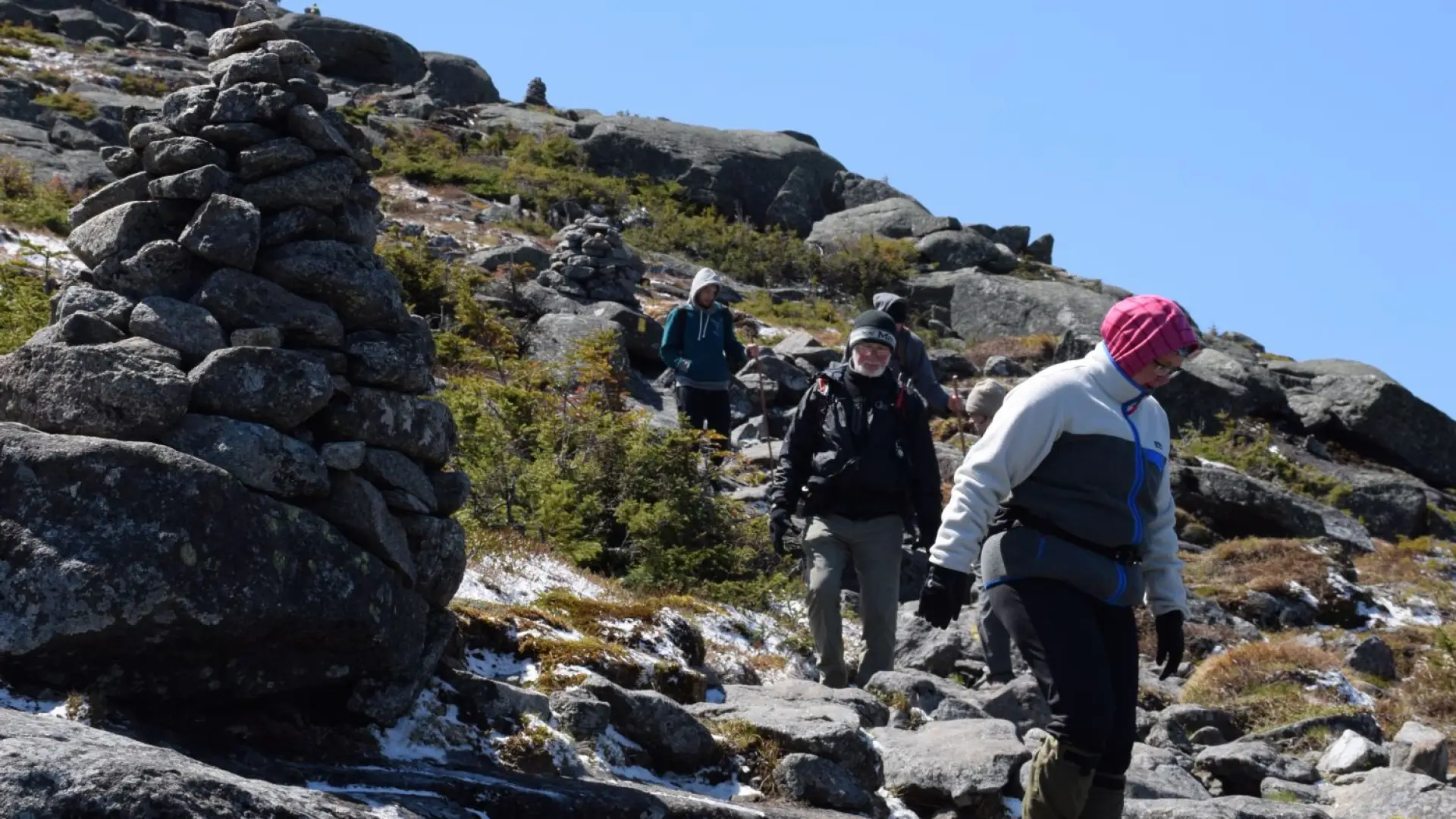 Hikers descend Algonquin's steep summit cone.
