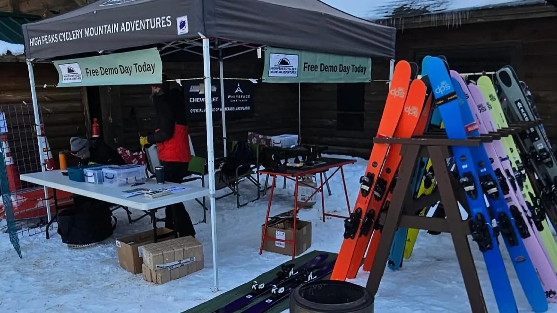 Pop-up tent with tables surrounded by skis