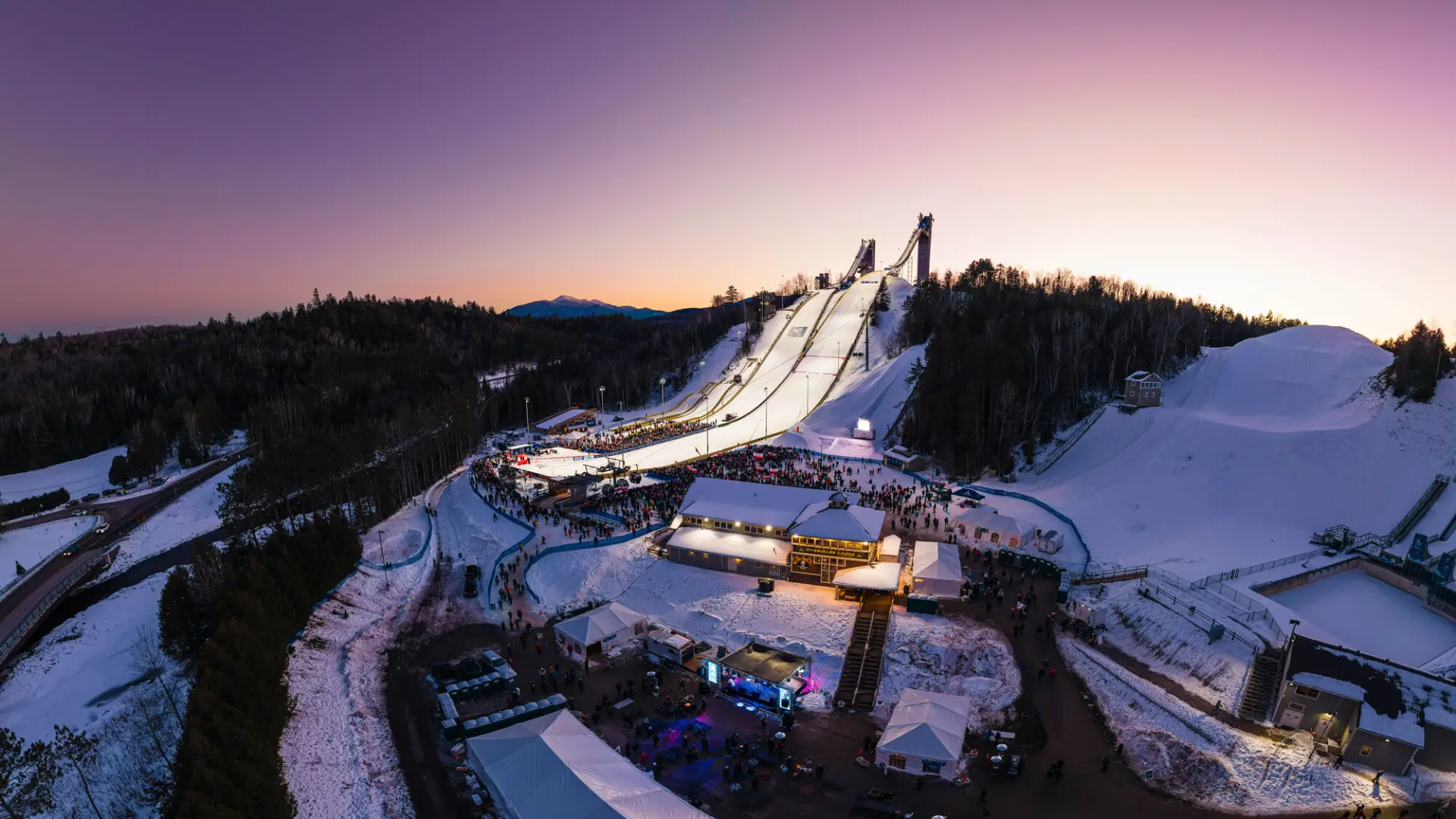 Ski jumps in winter during a night time event.