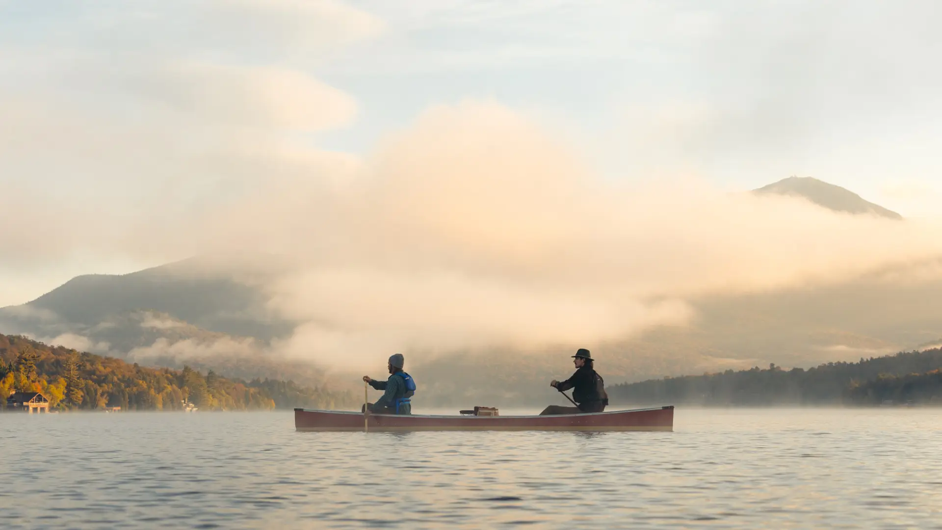 Two people paddling a canoe on Lake Placid.