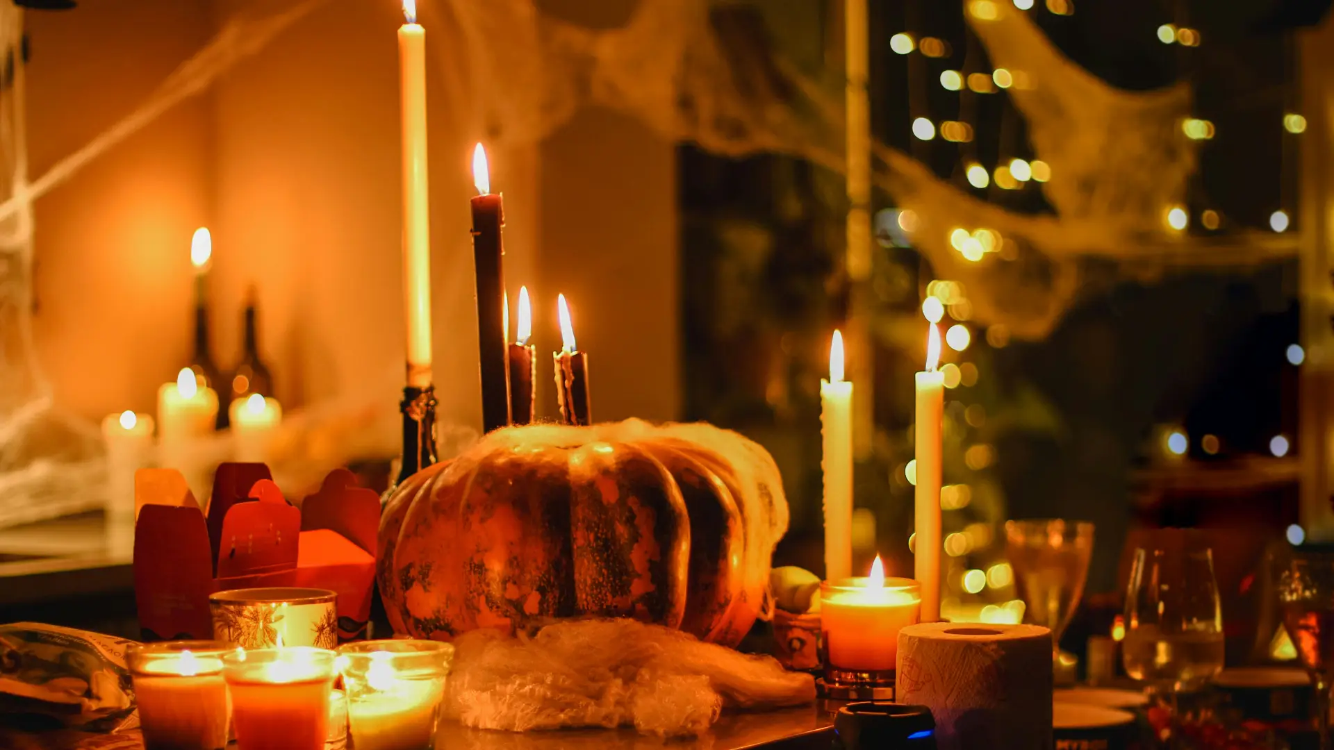 Pumpkins and candles on table