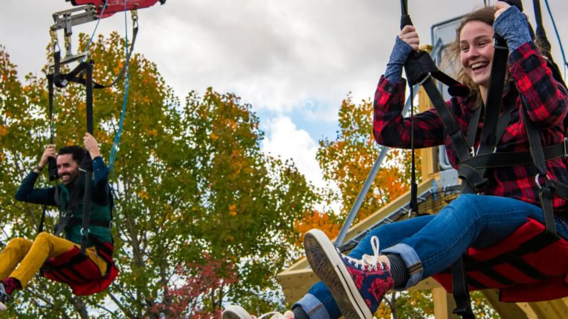 A couple smiles as they start the zipline