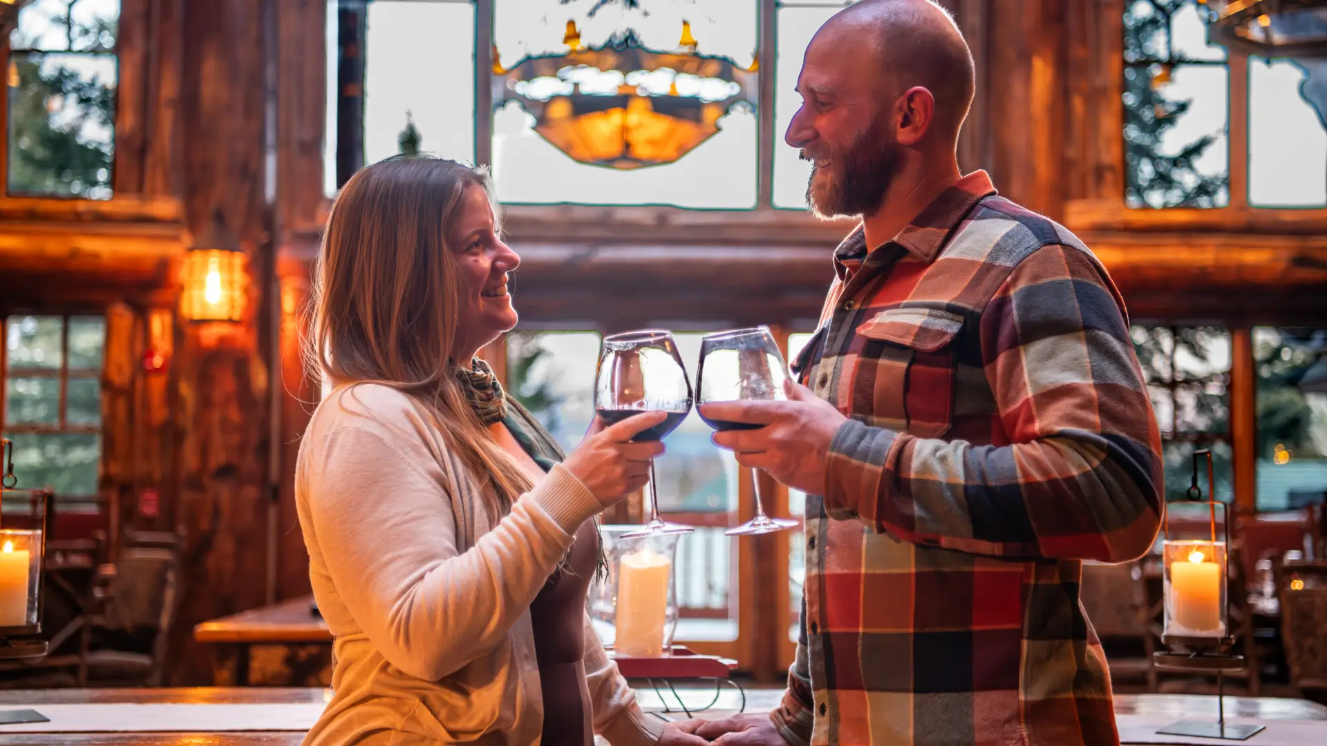 A couple cheerses their wine together.
