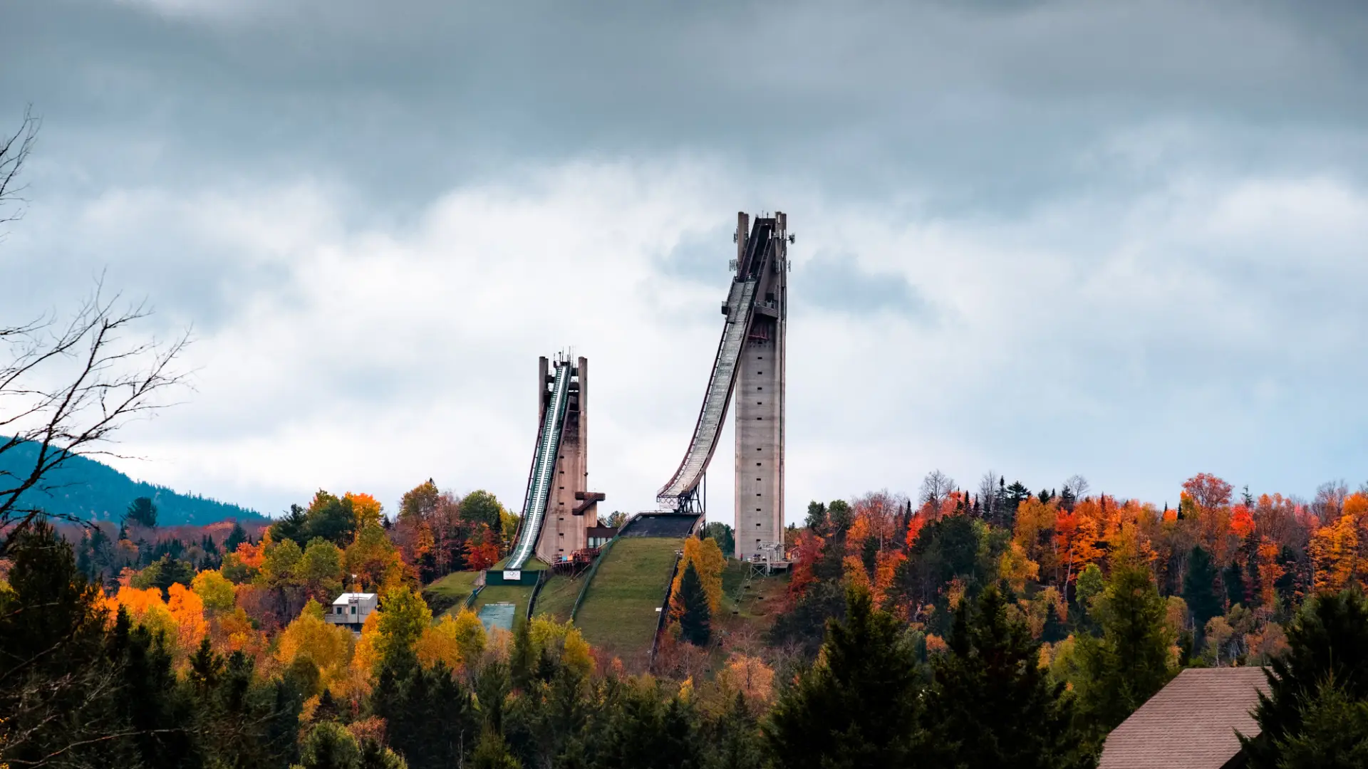 Ski jumps over fall foliage.