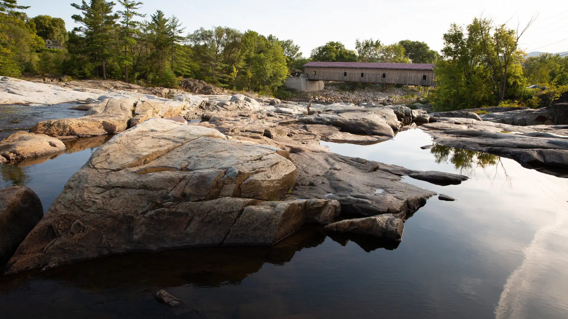 Shallow pools of water near a covered bridge